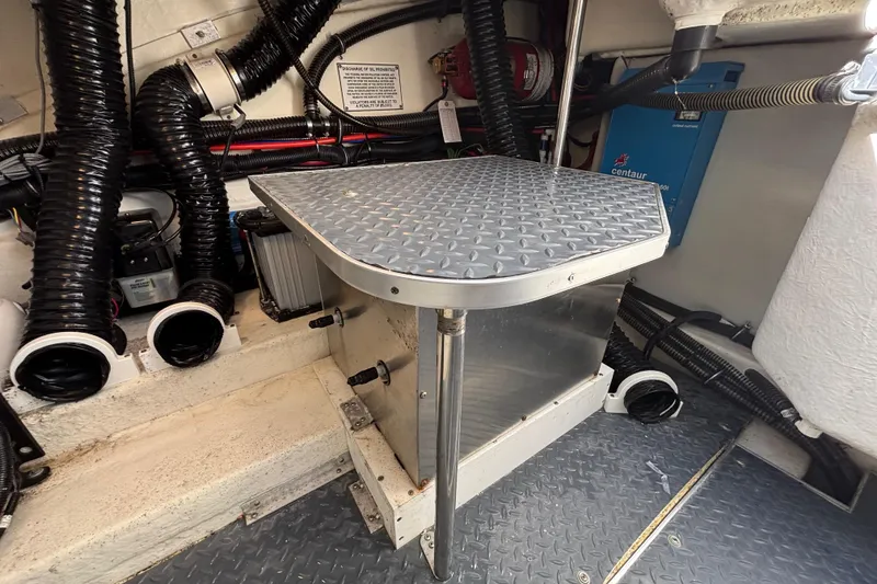 Slide: The Image of 2019 Formula 350 Crossover Bowrider OB engine compartment with metal platform and wiring. - 80