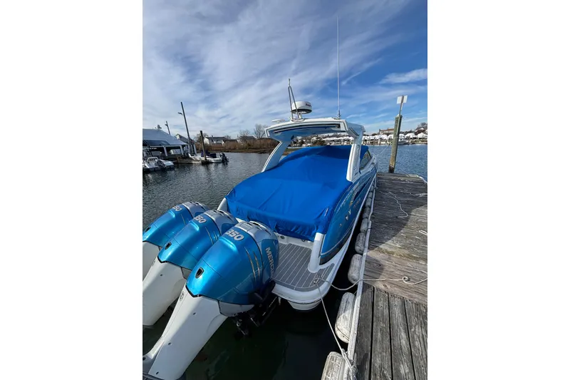 Slide: The Image of 2019 Formula 350 Crossover Bowrider OB docked, featuring triple Mercury outboard engines. - 82