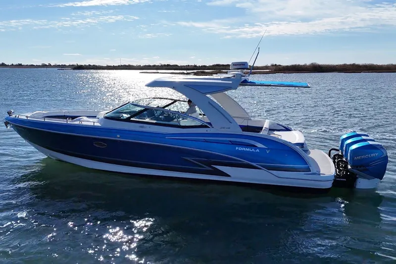 Slide: The Image of 2019 Formula 350 Crossover Bowrider OB on water, featuring sleek blue design and Mercury outboard engines. - 9