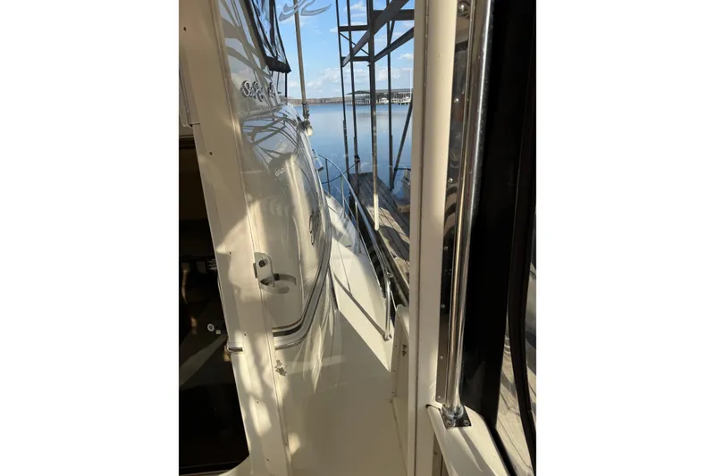 Slide: The Image of 1997 Sea Ray 370 Aft Cabin yacht docked, showcasing sleek exterior design. - 11