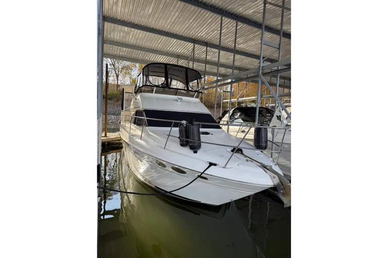 Slide: The Image of 1997 Sea Ray 370 Aft Cabin yacht docked in a covered marina. - 2