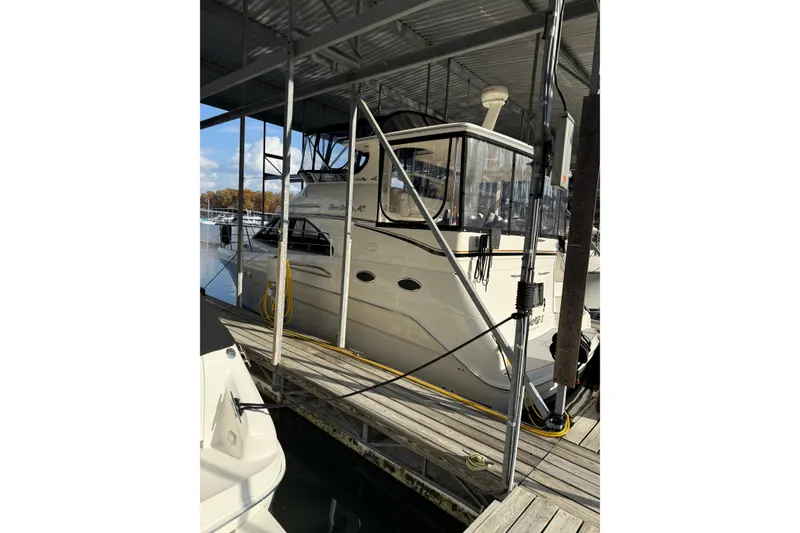 Slide: The Image of 1997 Sea Ray 370 Aft Cabin yacht docked in a marina under a covered structure. - 3