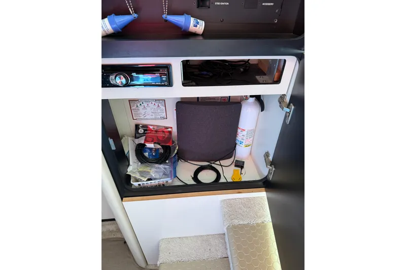 Slide: The Image of 1997 Sea Ray 370 Aft Cabin interior storage with fire extinguisher and audio equipment. - 30