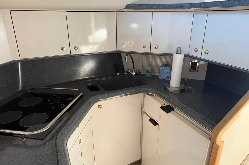 Slide: The Image of 1997 Sea Ray 370 Aft Cabin kitchen with modern appliances and sleek cabinetry. - 32