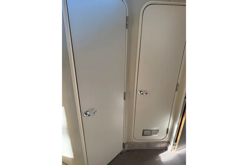 Slide: The Image of 1997 Sea Ray 370 Aft Cabin interior doors with chrome handles. - 33