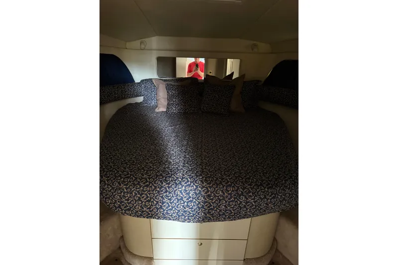 Slide: The Image of 1997 Sea Ray 370 Aft Cabin interior with cozy bed and patterned bedding. - 37
