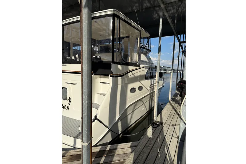 Slide: The Image of 1997 Sea Ray 370 Aft Cabin yacht docked in marina, side view. - 4