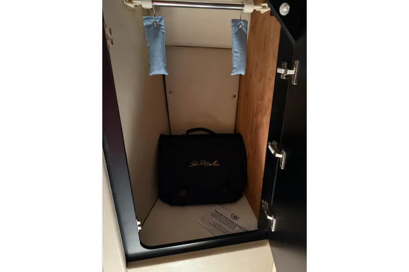 Slide: The Image of 1997 Sea Ray 370 Aft Cabin closet with bag and hanging sachets. - 41