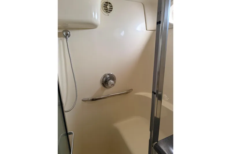 Slide: The Image of Shower area in 1997 Sea Ray 370 Aft Cabin yacht, featuring chrome fixtures. - 54