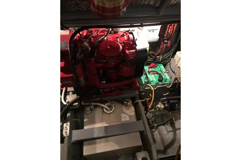 Slide: The Image of Engine room of 1997 Sea Ray 370 Aft Cabin with red engine and wiring. - 57