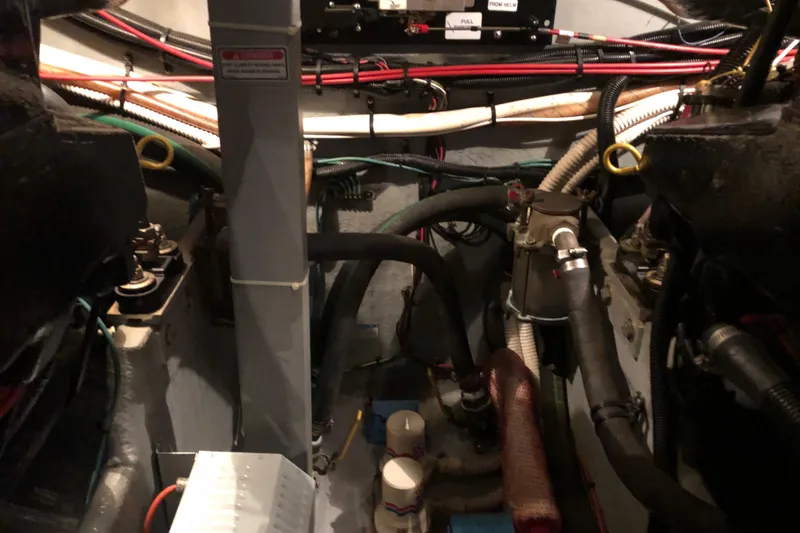 Slide: The Image of Engine room of a 1997 Sea Ray 370 Aft Cabin with visible wiring and components. - 64