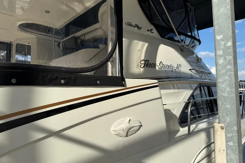 Slide: The Image of 1997 Sea Ray 370 Aft Cabin yacht docked, showcasing sleek design and elegant detailing. - 7