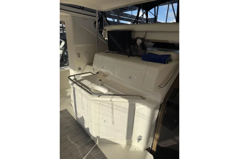 Slide: The Image of 1997 Sea Ray 370 Aft Cabin interior with sink, TV, and fan. - 8