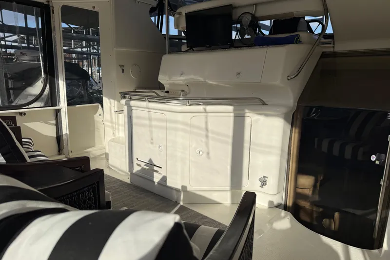 Slide: The Image of 1997 Sea Ray 370 Aft Cabin interior with seating and entertainment area. - 9