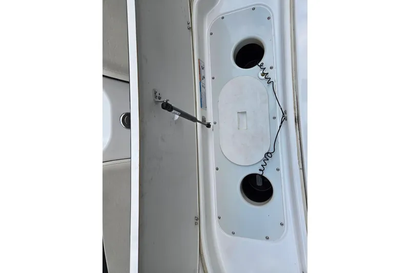 Slide: The Image of 2013 Yamaha Boats 212X interior compartment with storage and cup holders. - 12