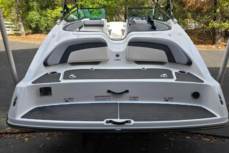 Slide: The Image of 2013 Yamaha Boats 212X rear view, showcasing sleek design and spacious seating. - 15