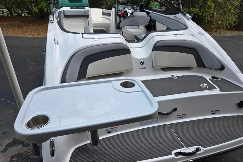 Slide: The Image of 2013 Yamaha Boats 212X interior with seating and table, showcasing luxury and functionality. - 2