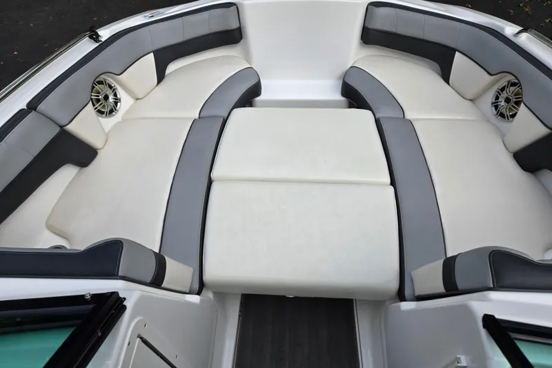 Slide: The Image of Luxurious seating area on a 2013 Yamaha Boats 212X, featuring sleek design and speakers. - 4