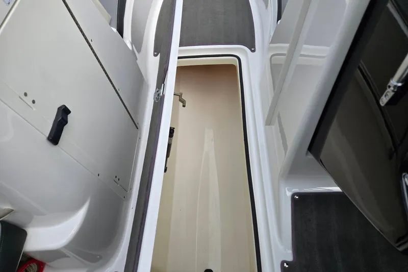 Slide: The Image of 2013 Yamaha Boats 212X interior storage compartment, featuring sleek design and ample space. - 7