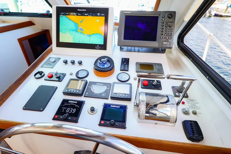 Slide: The Image of Control panel of a 2005 New England Boatworks Downeast Sedan with navigation equipment. - 12