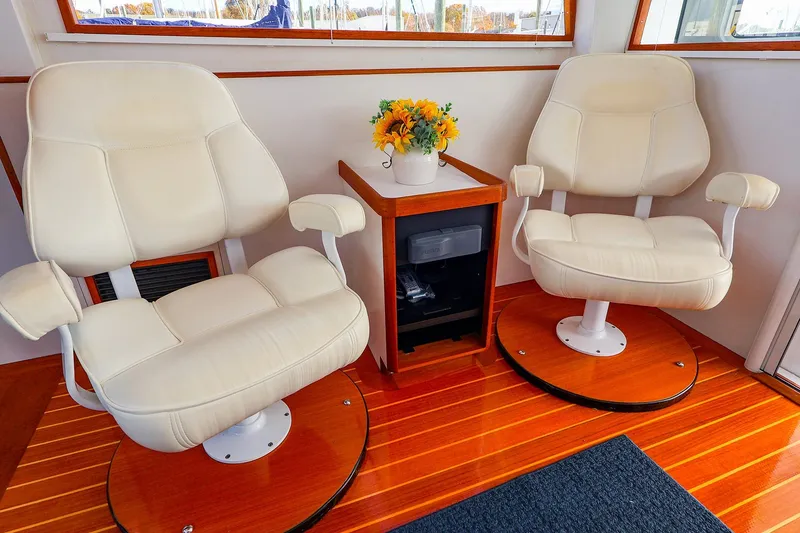 Slide: The Image of Luxurious interior of 2005 New England Boatworks Downeast Sedan with plush seating and floral decor. - 16