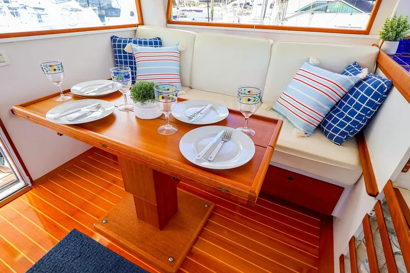 Slide: The Image of Elegant dining area on 2005 New England Boatworks Downeast Sedan, featuring nautical-themed decor. - 30