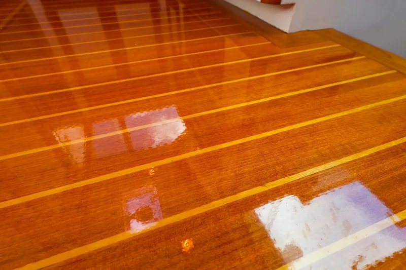 Slide: The Image of Polished wooden deck of 2005 New England Boatworks Downeast Sedan yacht. - 32