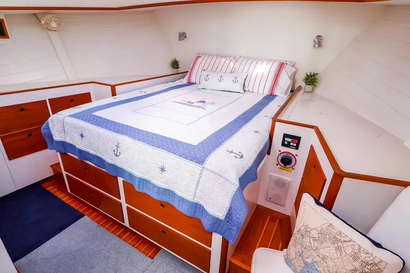 Slide: The Image of Cozy cabin interior of 2005 New England Boatworks Downeast Sedan with nautical-themed bedding. - 34