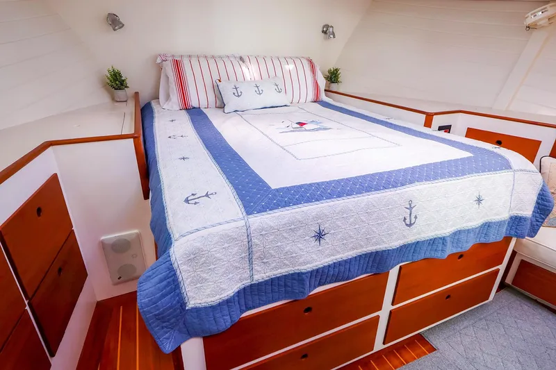 Slide: The Image of Cozy cabin bedroom in 2005 New England Boatworks Downeast Sedan, nautical-themed bedding. - 35