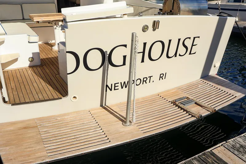 Slide: The Image of 2005 New England Boatworks Downeast Sedan, docked in Newport, RI, with wooden deck. - 9