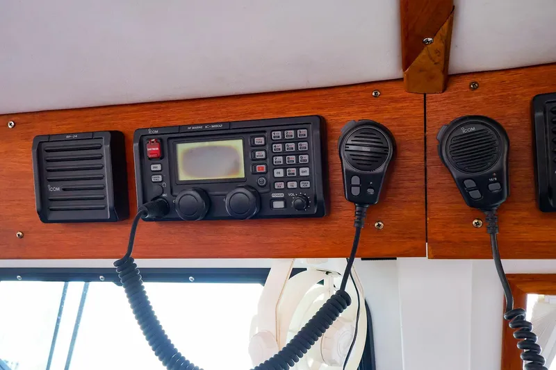 Slide: The Image of 2005 New England Boatworks Downeast Sedan radio equipment with Icom marine communication system. - 13