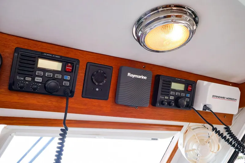 Slide: The Image of 2005 New England Boatworks Downeast Sedan with marine communication equipment and lighting. - 14