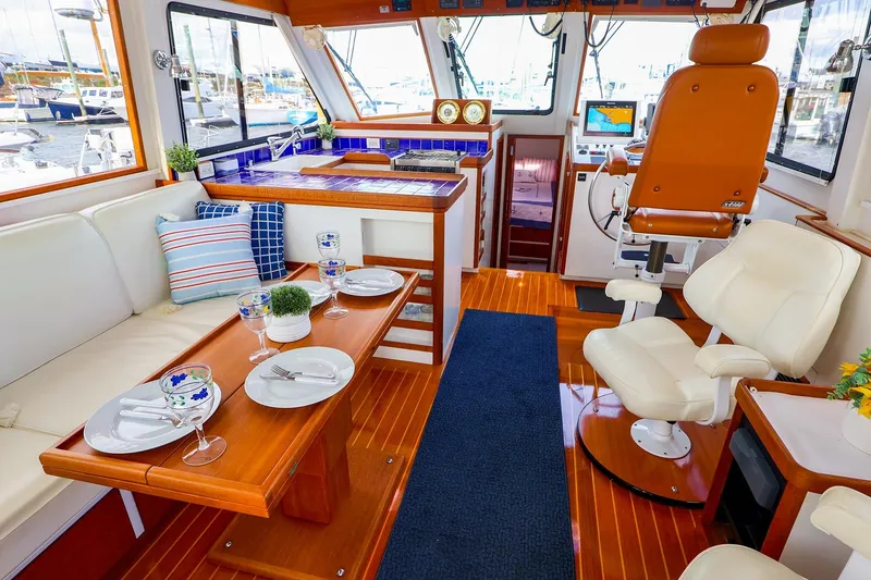 Slide: The Image of Luxurious 2005 New England Boatworks Downeast Sedan interior with elegant seating and dining area. - 17