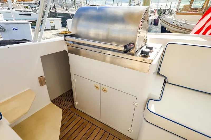 Slide: The Image of Outdoor grill and seating area on 2005 New England Boatworks Downeast Sedan yacht. - 24