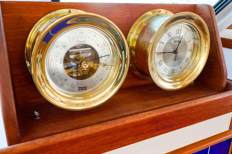 Slide: The Image of Brass barometer and clock on 2005 New England Boatworks Downeast Sedan. - 26