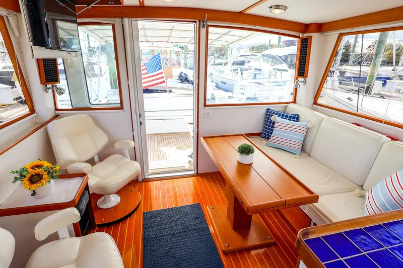 Slide: The Image of Interior of 2005 New England Boatworks Downeast Sedan with seating and decor. - 27