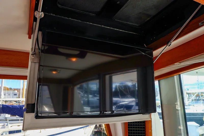 Slide: The Image of Flat-screen TV inside 2005 New England Boatworks Downeast Sedan yacht interior. - 29