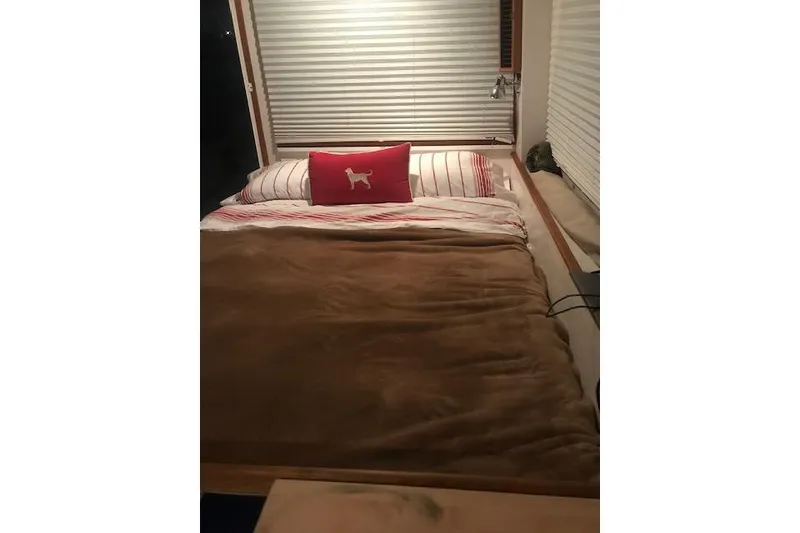 Slide: The Image of Cozy bedroom interior in 2005 New England Boatworks Downeast Sedan with striped bedding. - 37