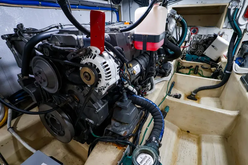 Slide: The Image of Engine room of 2005 New England Boatworks Downeast Sedan, showcasing detailed mechanical components. - 42