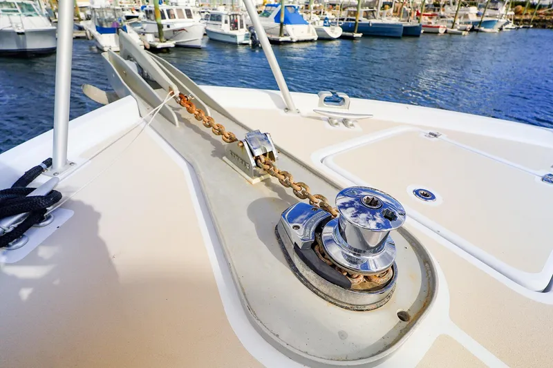 Slide: The Image of 2005 New England Boatworks Downeast Sedan anchor chain and winch on deck. - 5