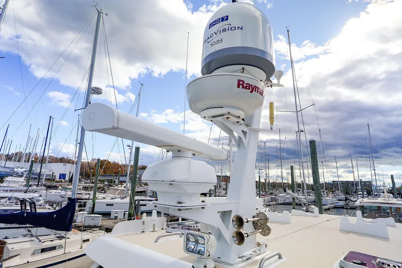 Slide: The Image of 2005 New England Boatworks Downeast Sedan with advanced radar equipment in a marina. - 6