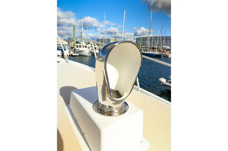 Slide: The Image of Chrome boat fitting on 2005 New England Boatworks Downeast Sedan, docked at marina. - 8