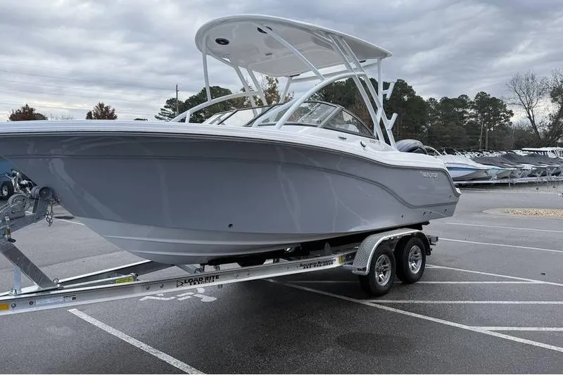 Slide: The Image of 2026 Sea Fox 228 Traveler boat on trailer, parked in a lot under cloudy skies. - 9
