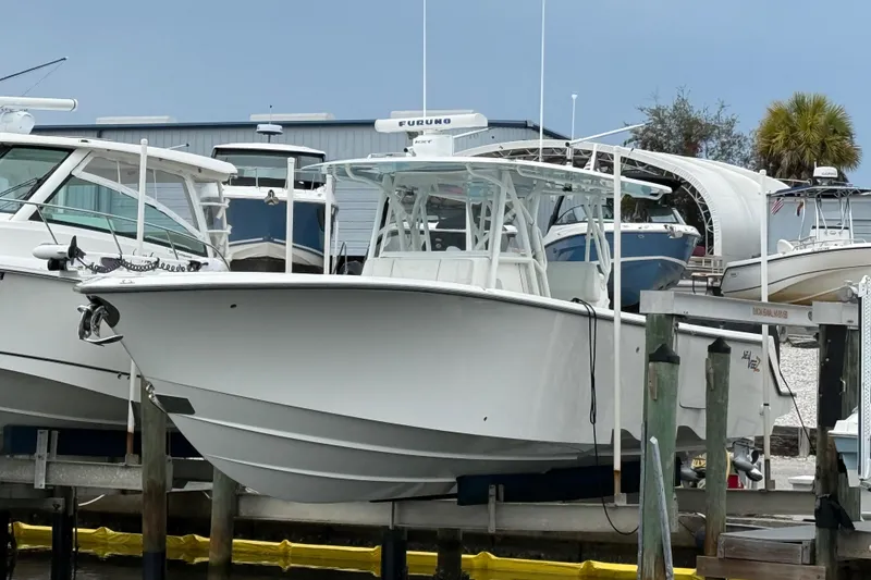 The Image of 2022 SeaVee 270Z boat docked at a marina, surrounded by other vessels. - 1
