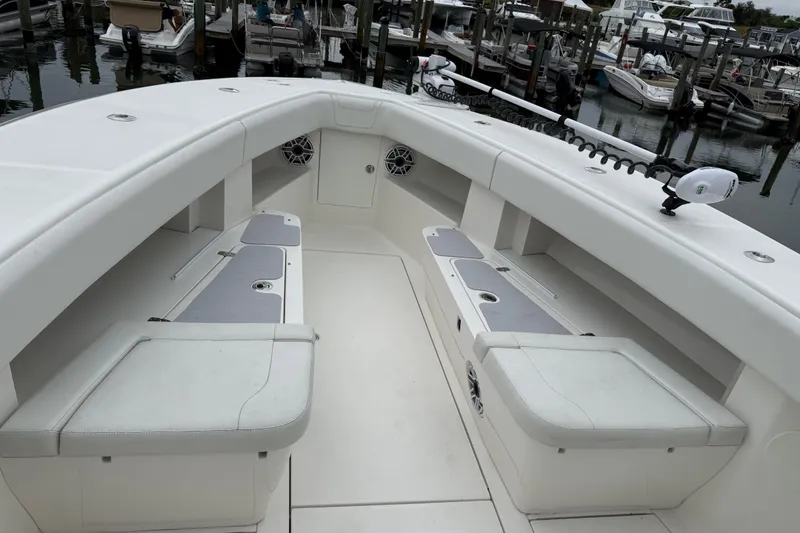 Slide: The Image of 2022 SeaVee 270Z boat interior with seating and storage, docked at marina. - 10