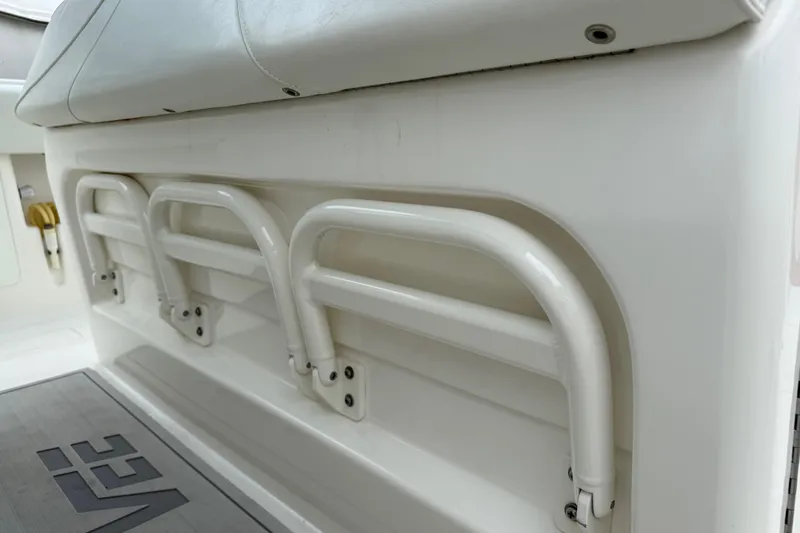 Slide: The Image of 2022 SeaVee 270Z boat interior with white seating and storage racks. - 13