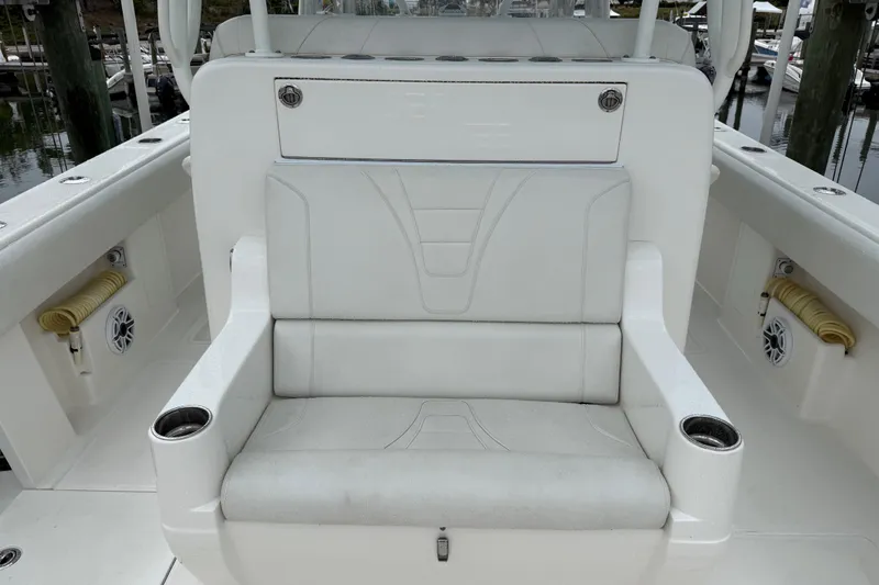 Slide: The Image of 2022 SeaVee 270Z boat interior with white cushioned seating and cup holders. - 14