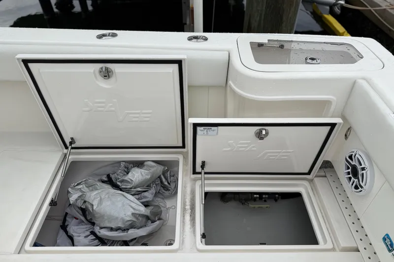 Slide: The Image of 2022 SeaVee 270Z boat storage compartments with open hatches and visible speaker. - 26