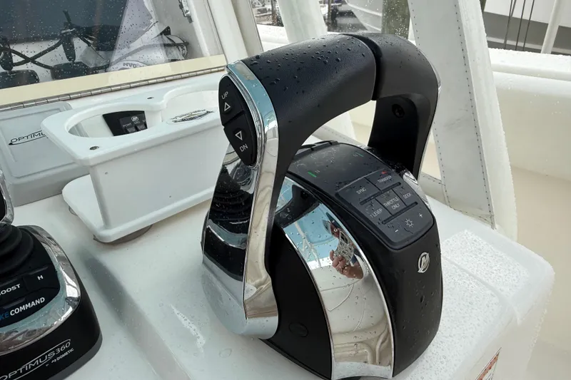 Slide: The Image of Close-up of 2022 SeaVee 270Z boat controls with water droplets. - 37