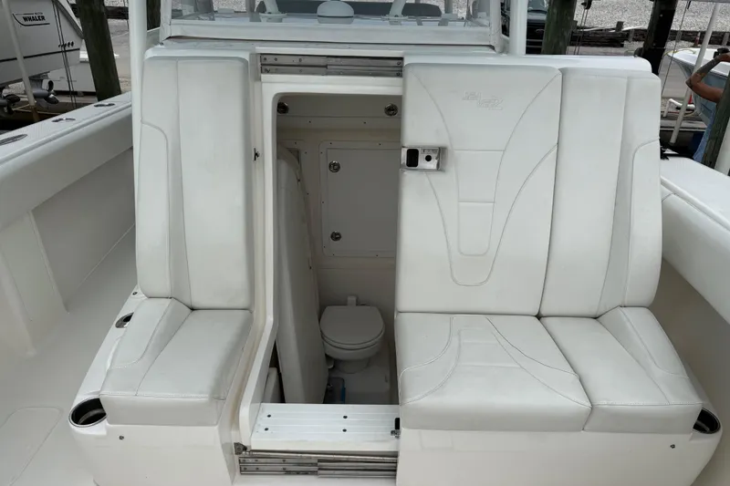 Slide: The Image of 2022 SeaVee 270Z boat interior with white seating and hidden toilet compartment. - 8